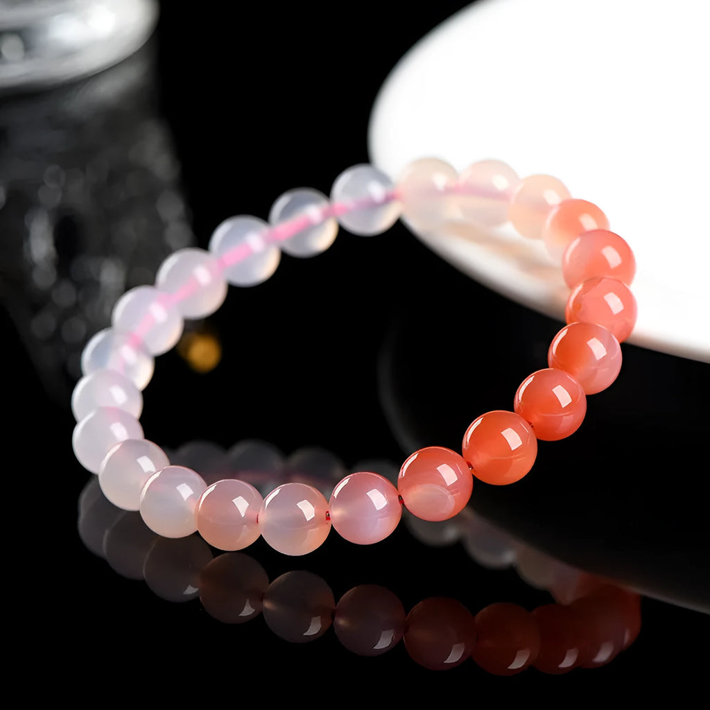 Natural gradient Yanyuan Agate bracelet showing graduated colour on geometrically shaped beads in a single circle.