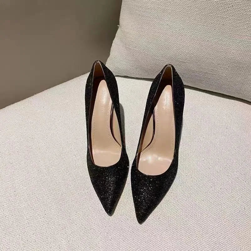 Silver and black women's stiletto bridal shoes with crystal decoration, showing different heel heights.