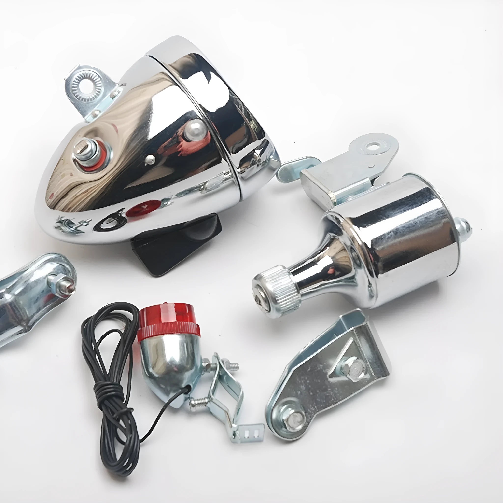 Silver aluminium bicycle dynamo light kit with generator, headlight, and tail light for friction-powered illumination.
