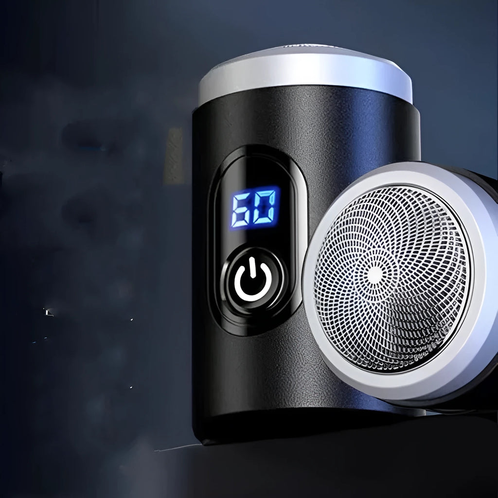 Black mini rechargeable shaver with USB cable and cleaning brush on a table