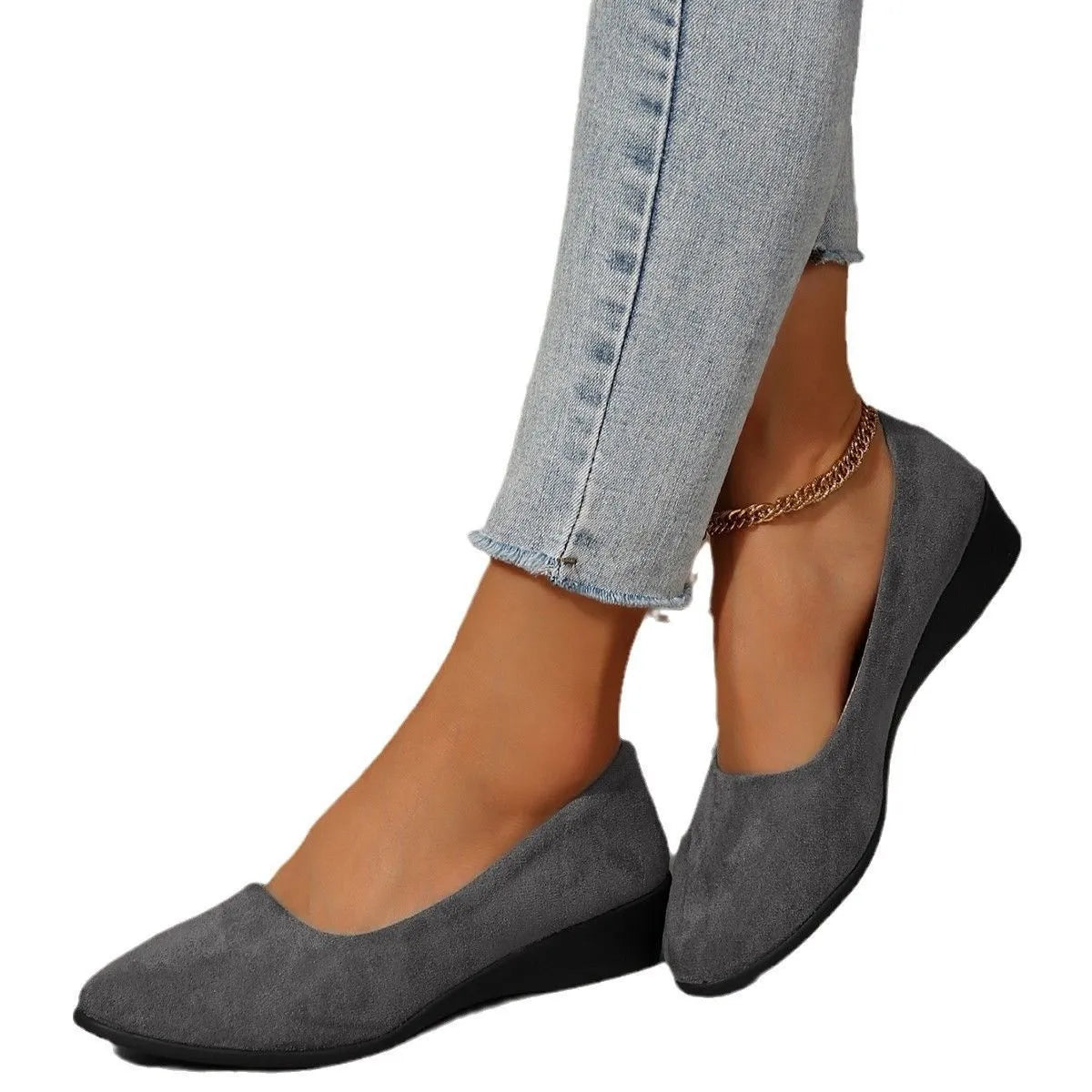 Women's black suede low wedge pumps with pointed toe and shallow mouth design on a rubber sole.