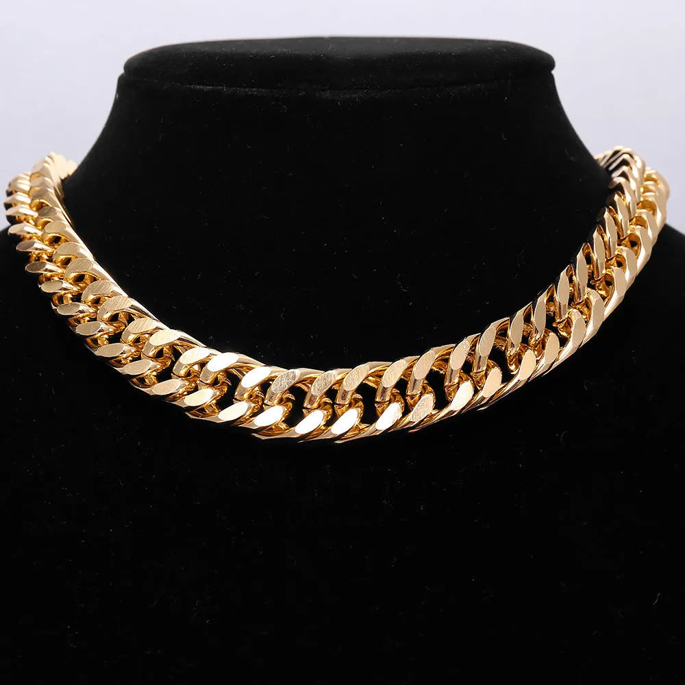Gold-toned women's thick chain necklace with red accents, showing chunky 6cm wide links on a 32cm chain.