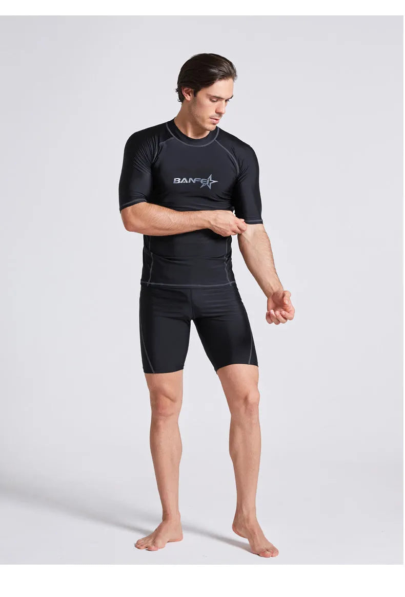 Men's navy blue quick-drying nylon swimsuit set with half-sleeve top and pants for swimming and surfing.
