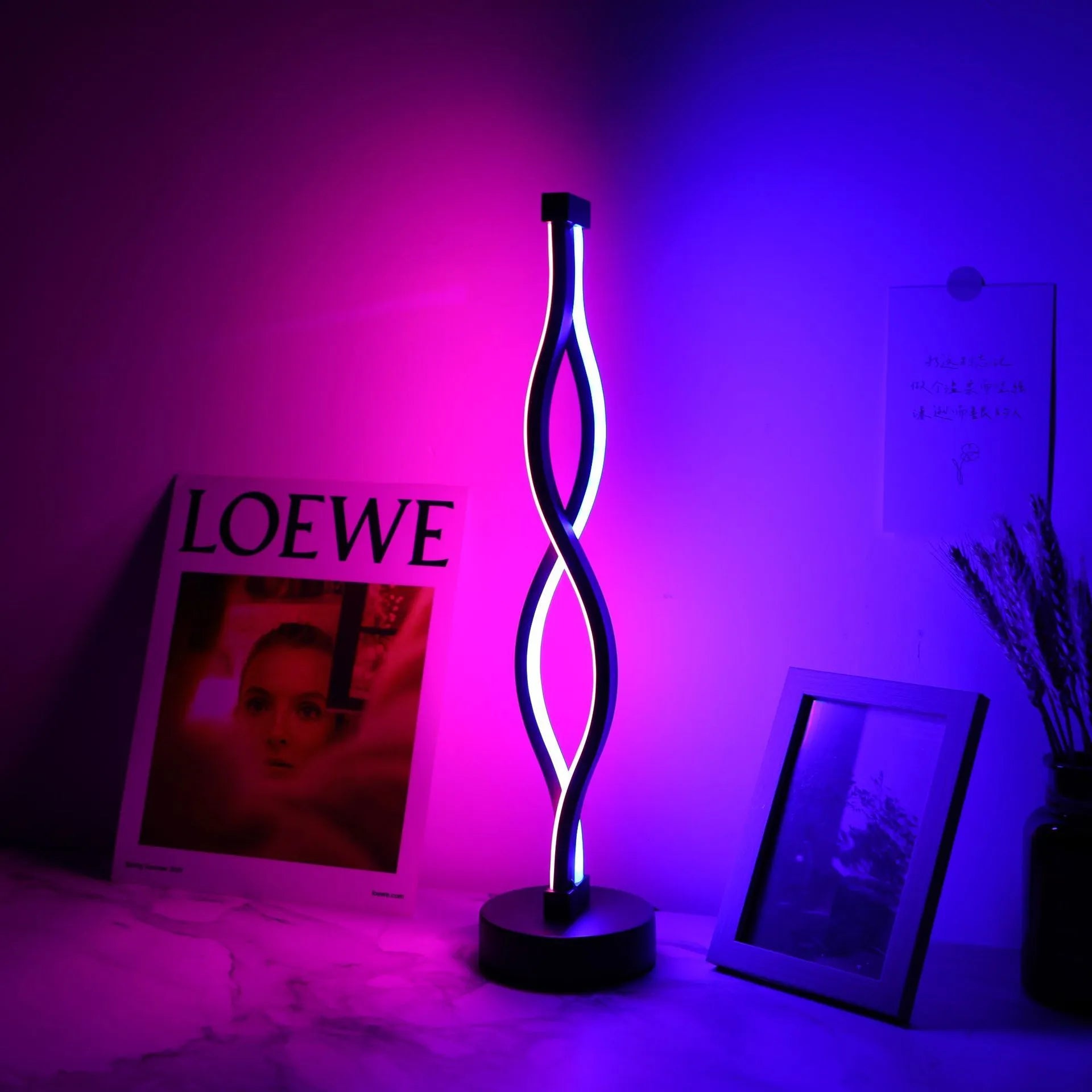 Black aluminium desk lamp with a touch dimming button for blue, pink, and warm white light.