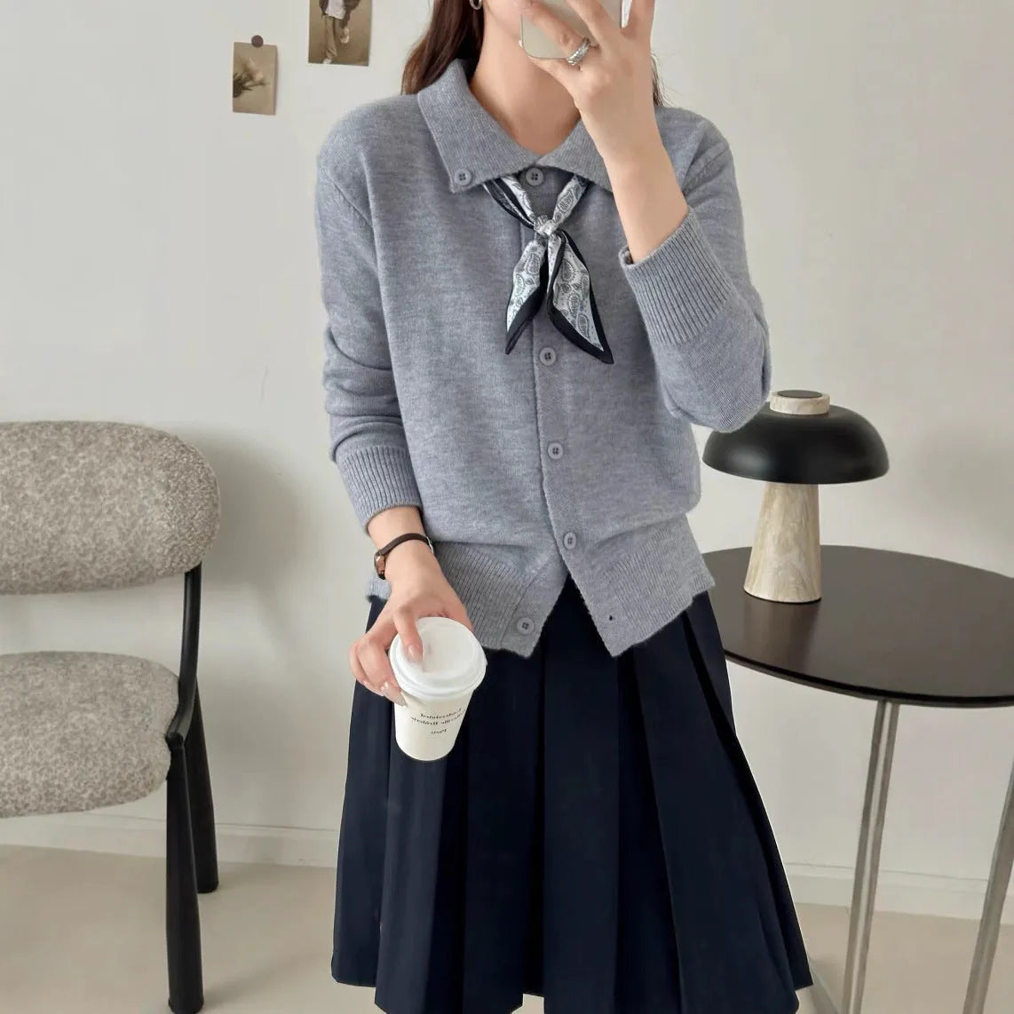 Beige lapel scarf cardigan sweater with long sleeves and splicing details on a model.