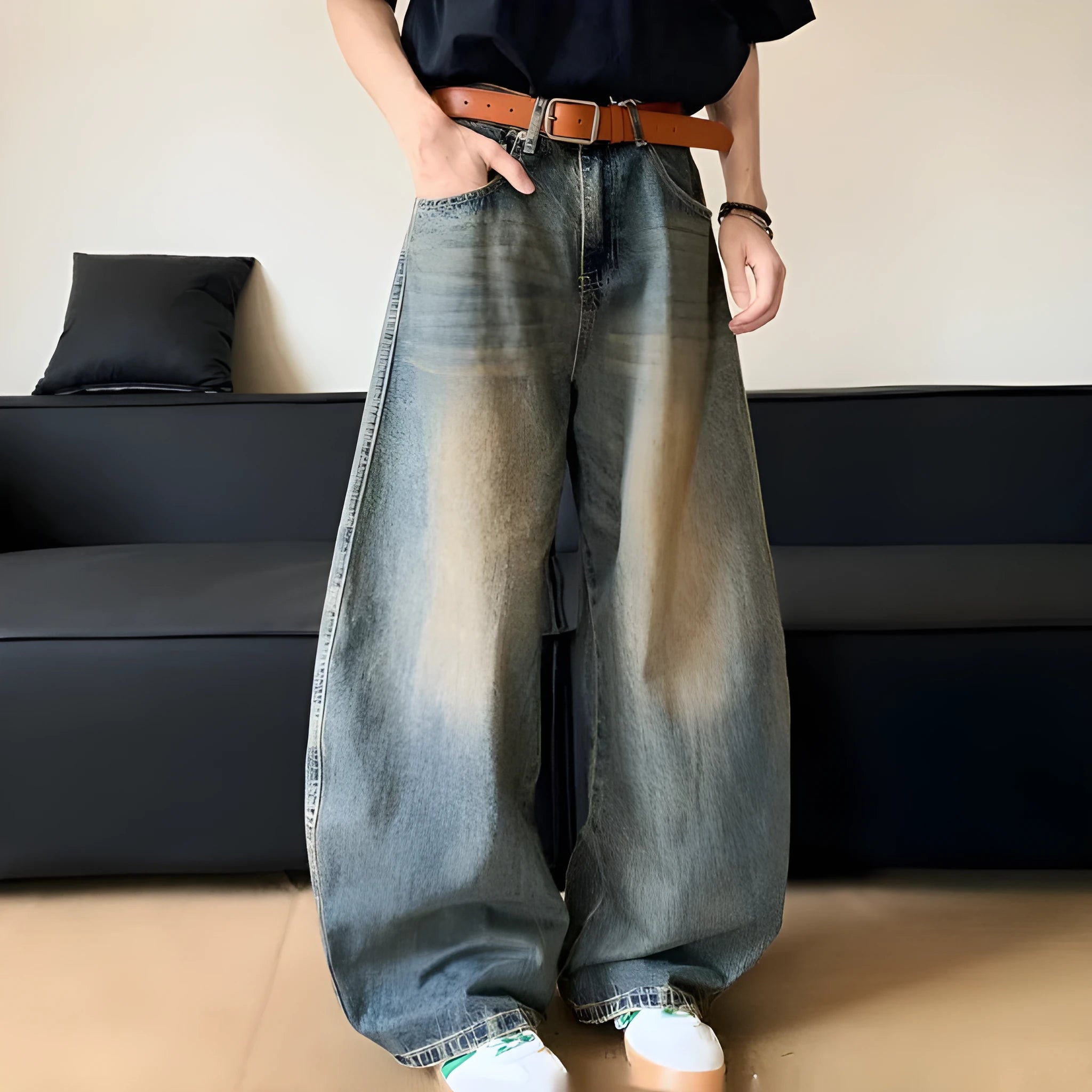 Man wearing retro blue distressed wide-leg denim jeans with a mid waist and zipper fly.