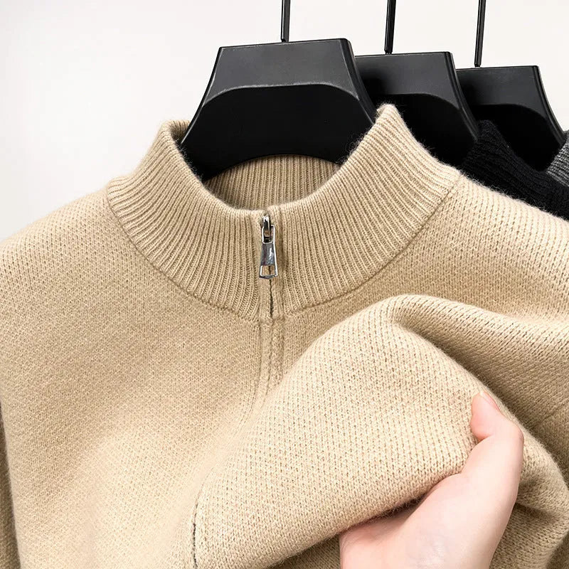 Man wearing a beige high collar zip-front knit cardigan, loose fit, long sleeves.