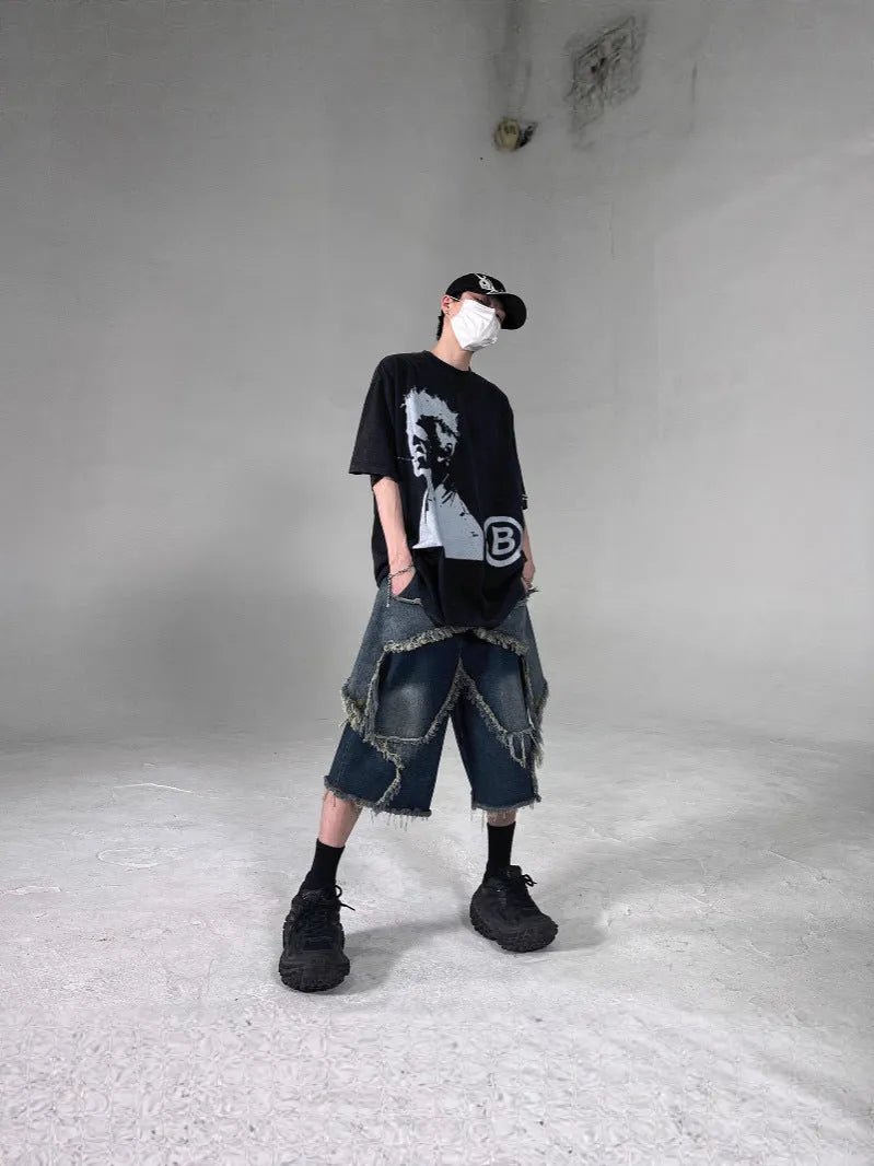 Blue denim shorts with frayed detailing and five-pointed star design in loose fit