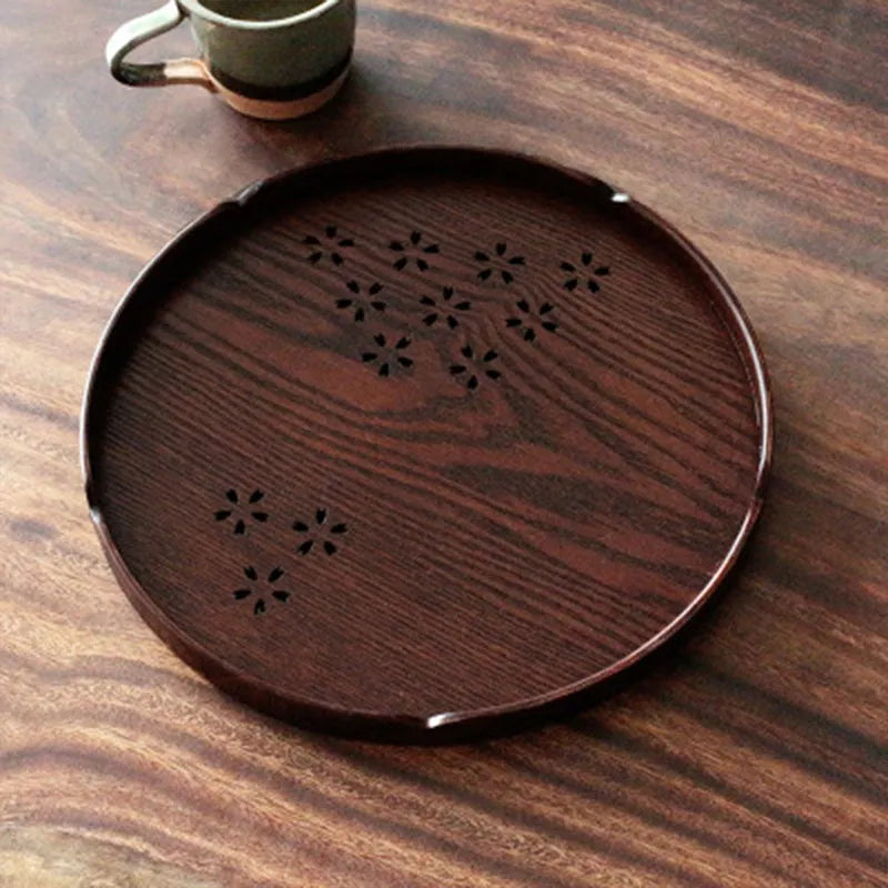 Wooden shallow plate with etched cherry blossom design, approximately 30 cm in diameter.