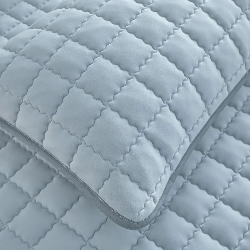 Washed cotton waterproof fitted sheet in light grey colour with elasticated corners on a mattress