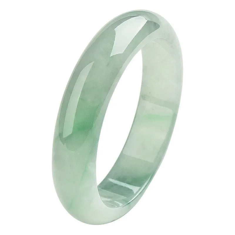 A light green jade bracelet for men and women, shown on a wrist, with a natural stone texture.