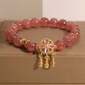 Women's strawberry quartz bracelet with four-leaf dream catcher pendant in natural crystal tones