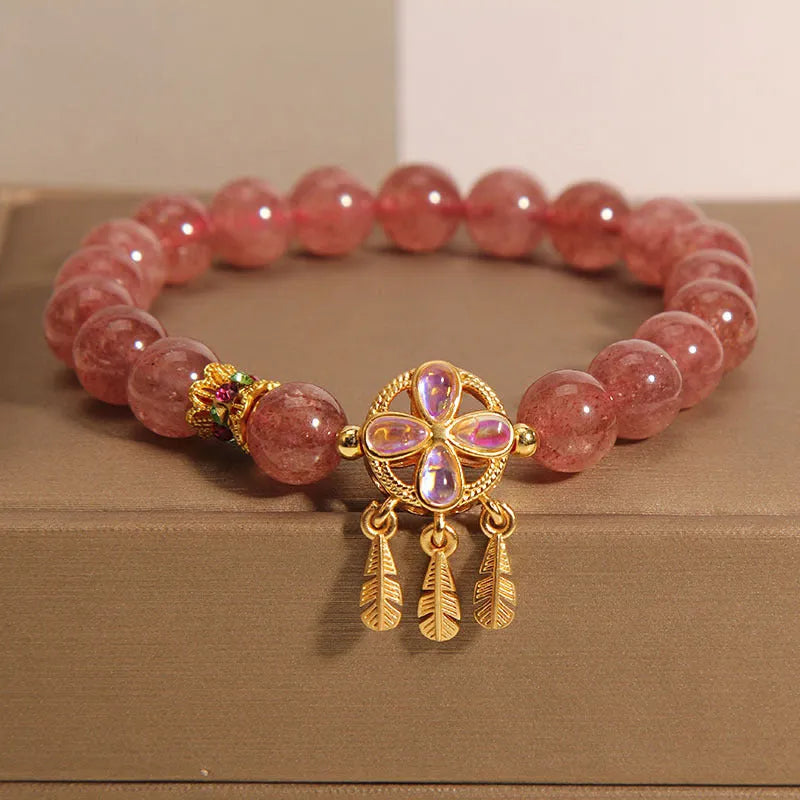 Women's strawberry quartz bracelet with four-leaf dream catcher pendant in natural crystal tones