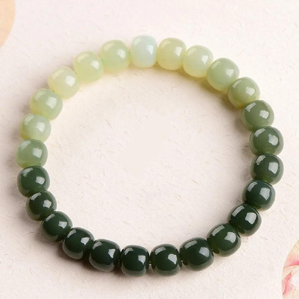 Polished Hetian jade bracelet with gradient clear water colour on wrist.