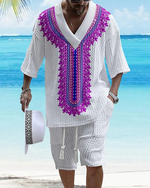 Man wearing a printed knitted drop-shoulder short-sleeved top with matching shorts from a co-ord suit set.