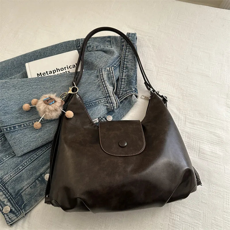 Large capacity PU leather commuter backpack with single shoulder strap in horizontal square design