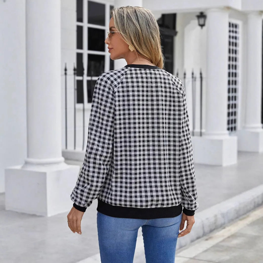Black long sleeve pullover sweater with a striped plaid pattern and printed design detail.