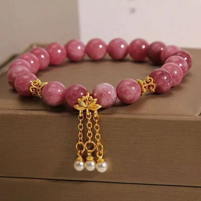 Women's natural stone bracelet with pearl pendant and pink lotus tassel on wrist