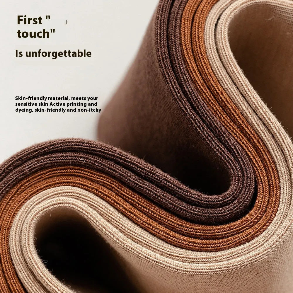 Men's solid colour mid-calf business socks made from combed cotton in various colours on a plain background.