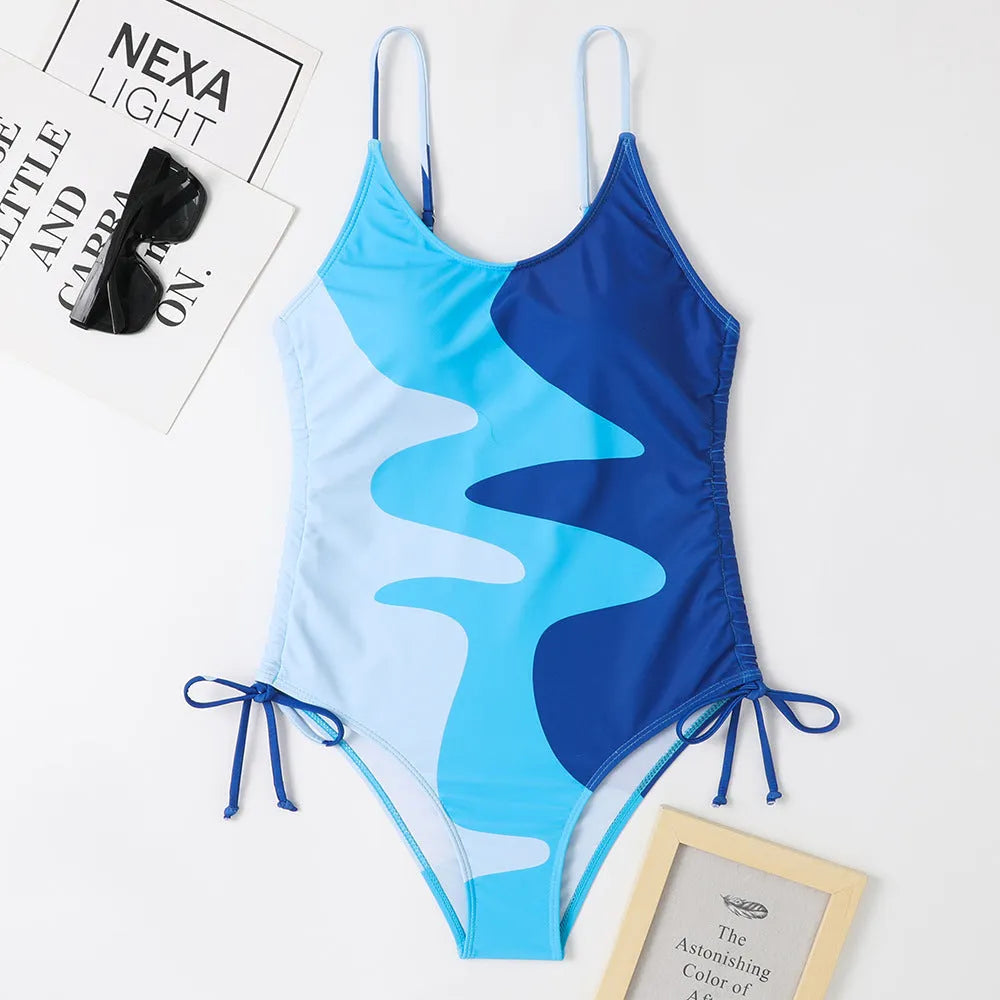 Blue women's sleeveless one-piece swimsuit with fixed swimming trunks on a mannequin.