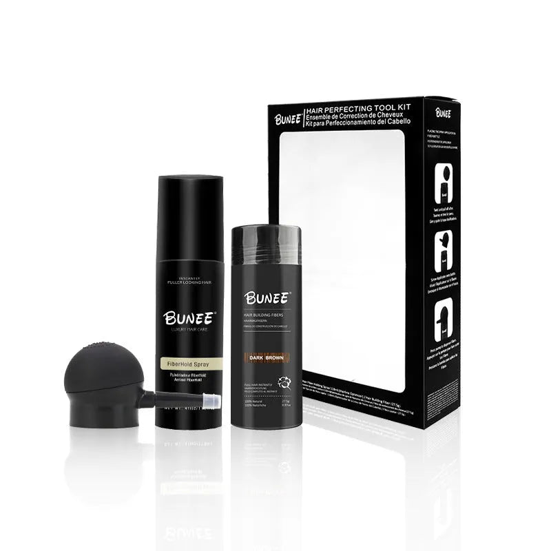 Box containing dense hair fibre powder canister, special applicator nozzle, and shaping spray bottle for hair styling.
