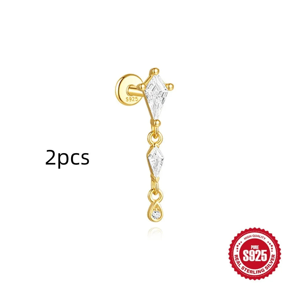Geometric kite-shaped sterling silver earring with rhinestone head and gold chain tassel.