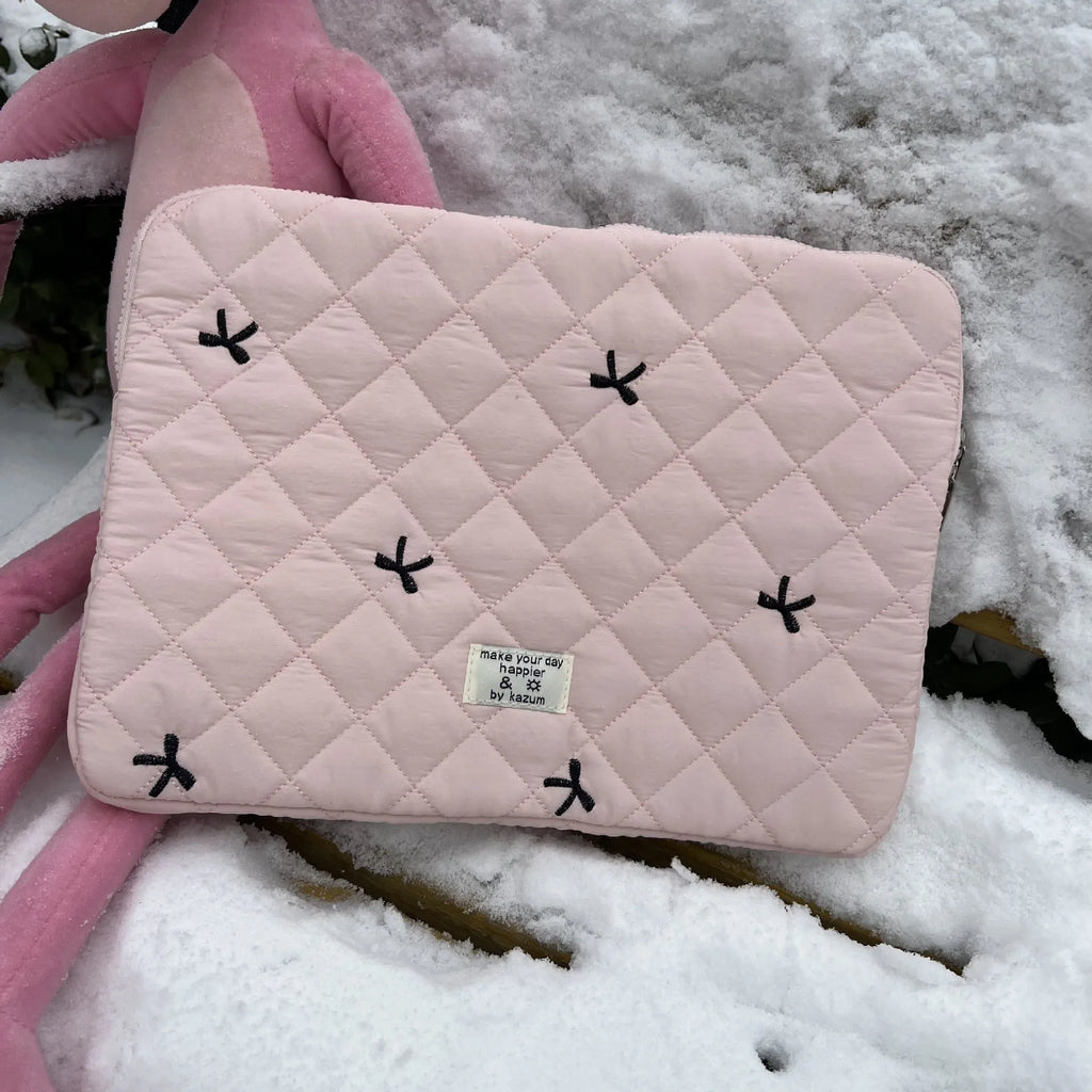 Nylon laptop storage bag with embroidered rhombus bow in light blue, showing size options.