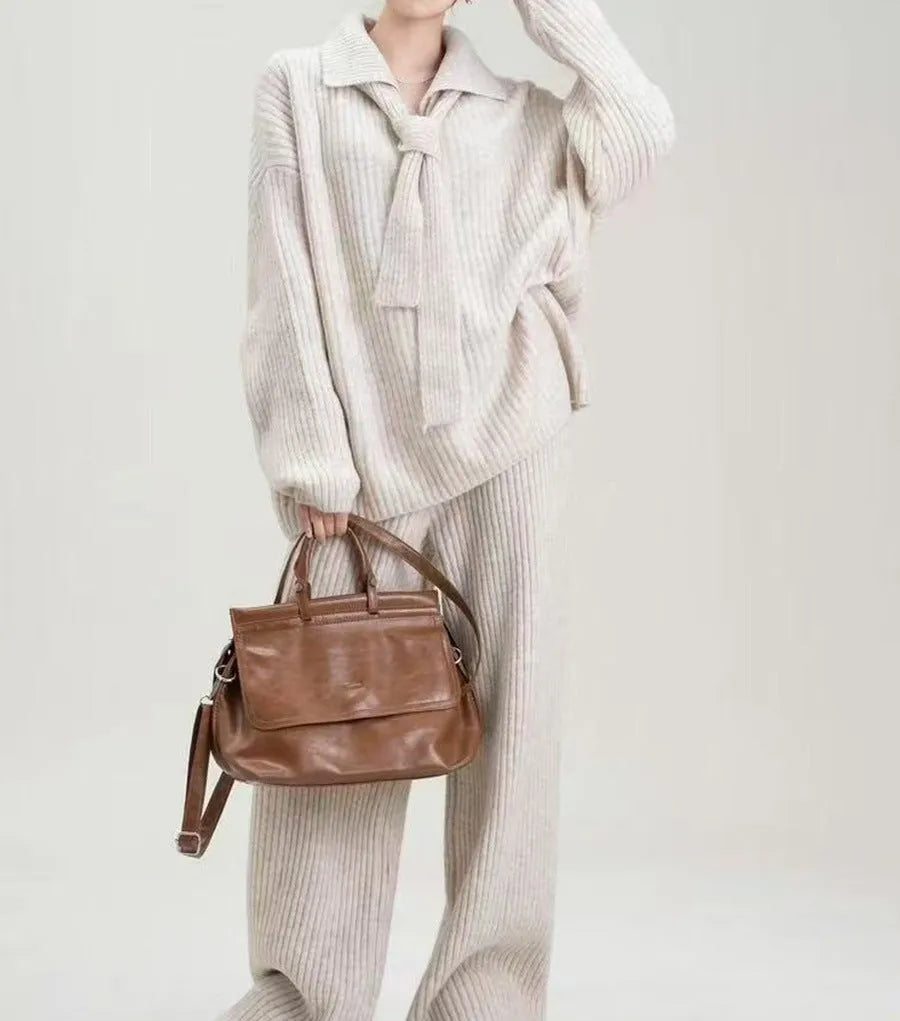 Beige imitation cashmere knitted top and matching trousers two-piece set laid flat.
