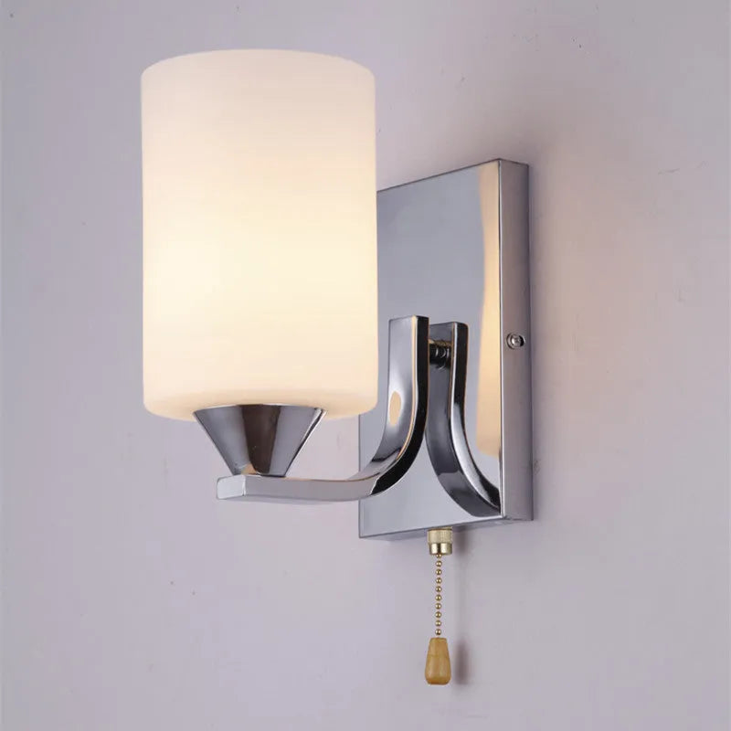 Modern chrome-finished wall lamp with a clear glass shade, shown in a single head configuration.