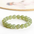 Hetian jade ball bracelet with polished spherical beads on a string, shown in deep and light clear water colour options.
