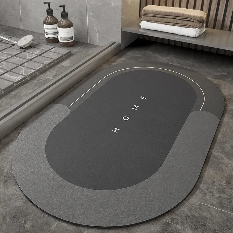 Blended fabric bathroom floor mat in blue colour, shown in an oval shape on a tiled floor.
