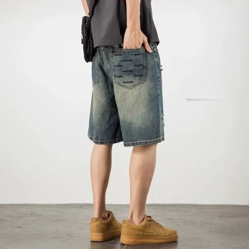 Blue men's denim shorts with a retro loose hole design and straight-leg cut.