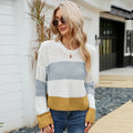 Women's short striped loose pullover sweater in acrylic knit on a hanger.