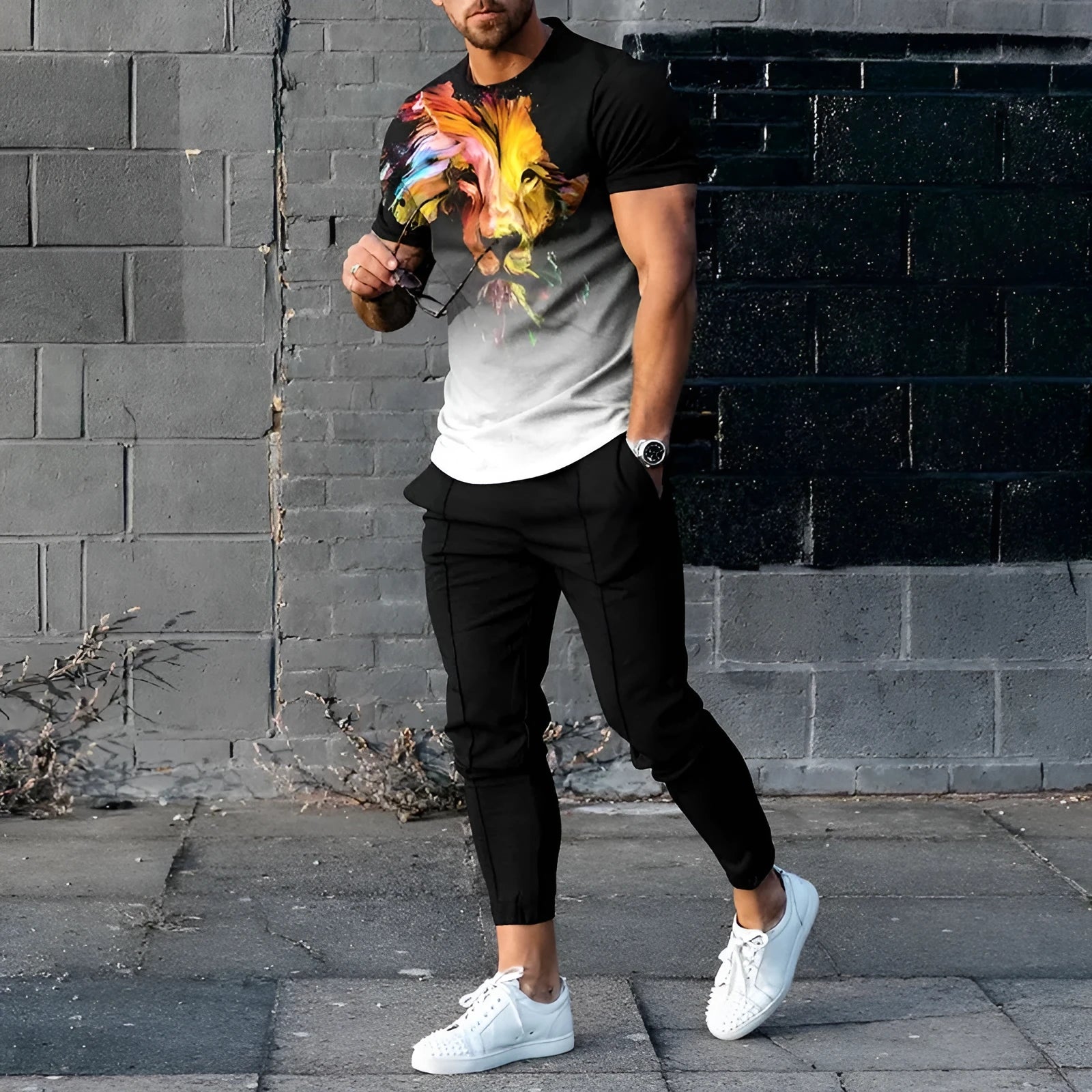 Man wearing a short-sleeved printed round neck pullover and matching trousers from a lightweight athletic suit set.