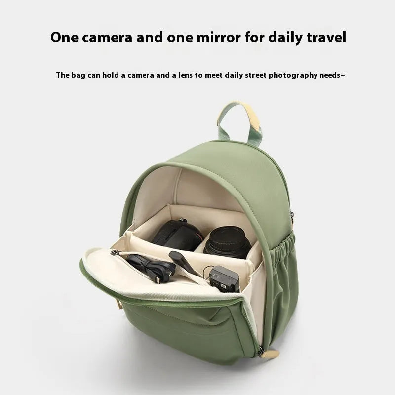 Women's polyester shoulder camera bag in black with a curved strap and detachable iPad pocket.