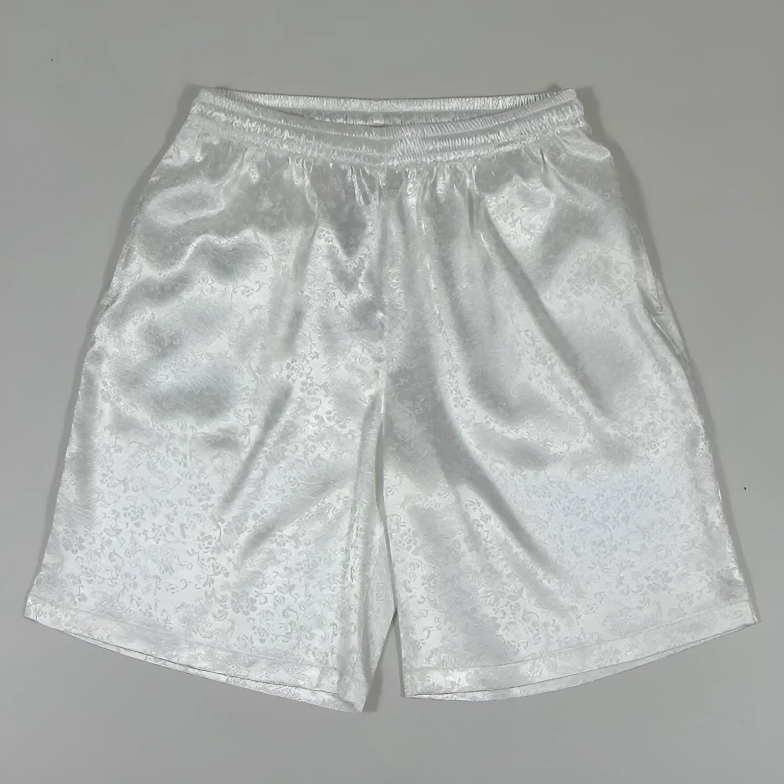 Men's black Tang Suit Tai Chi shorts with a white drawstring elastic waistband laid flat.
