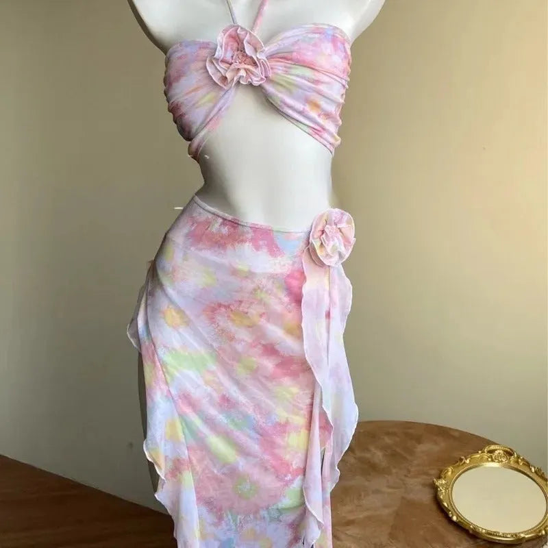 Women's floral split skirt-style swimsuit bikini three-piece set in pink with top, skirt, and panties