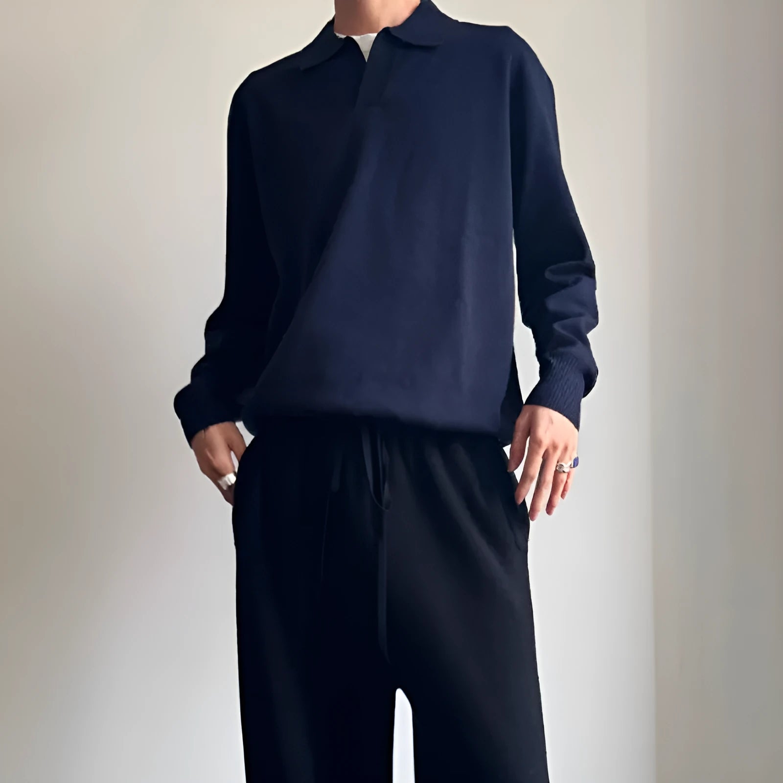 Pure wool polo sweater with lapel collar in loose fit, shown in milky white.