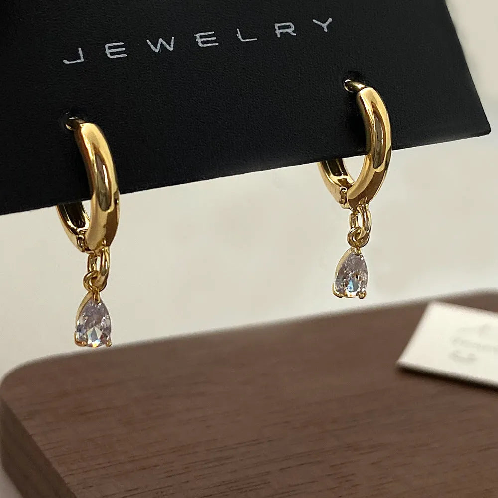 Zircon geometric necklace, earrings, and anklet set with meteor shower detail on a white background.