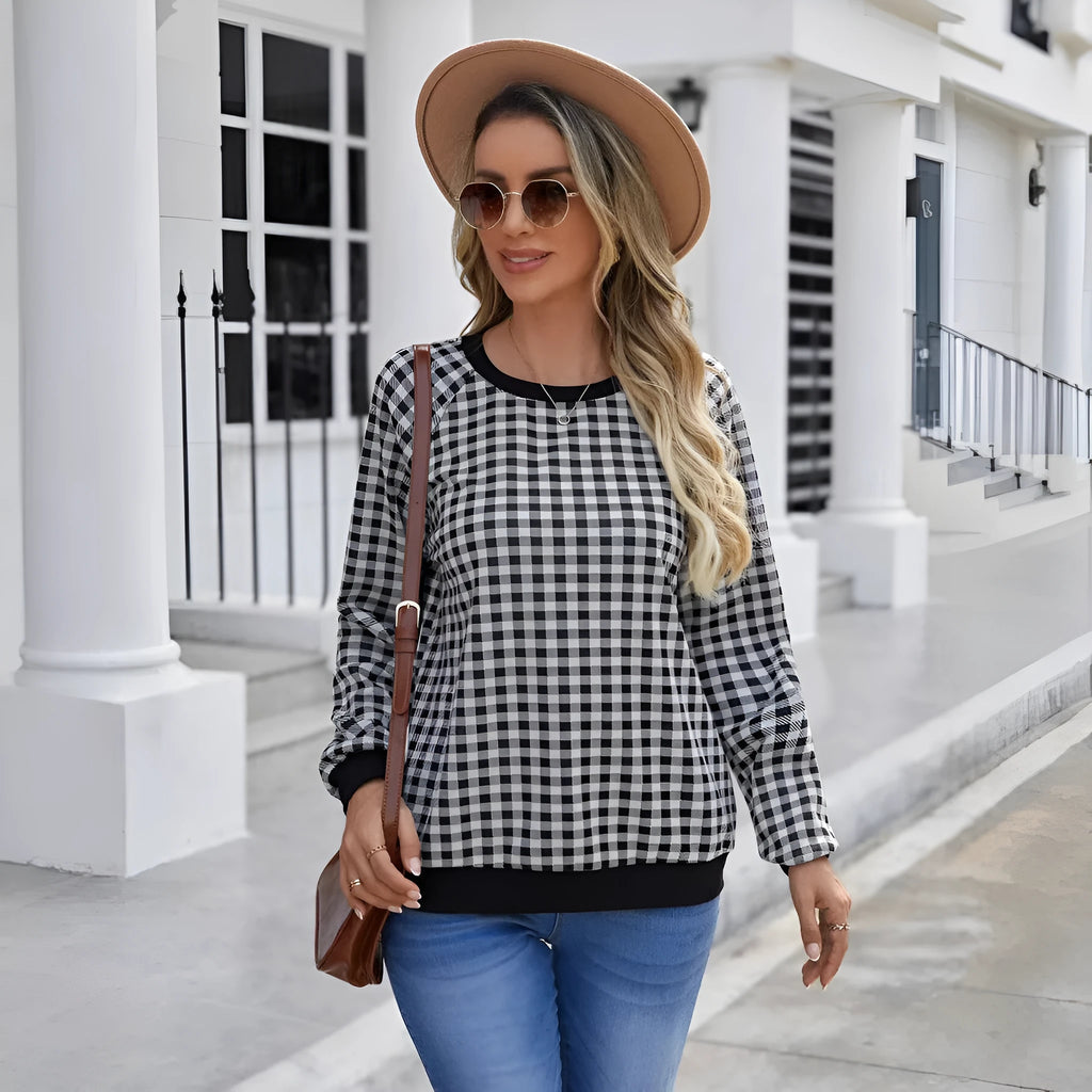 Black long sleeve pullover sweater with a striped plaid pattern and printed design detail.