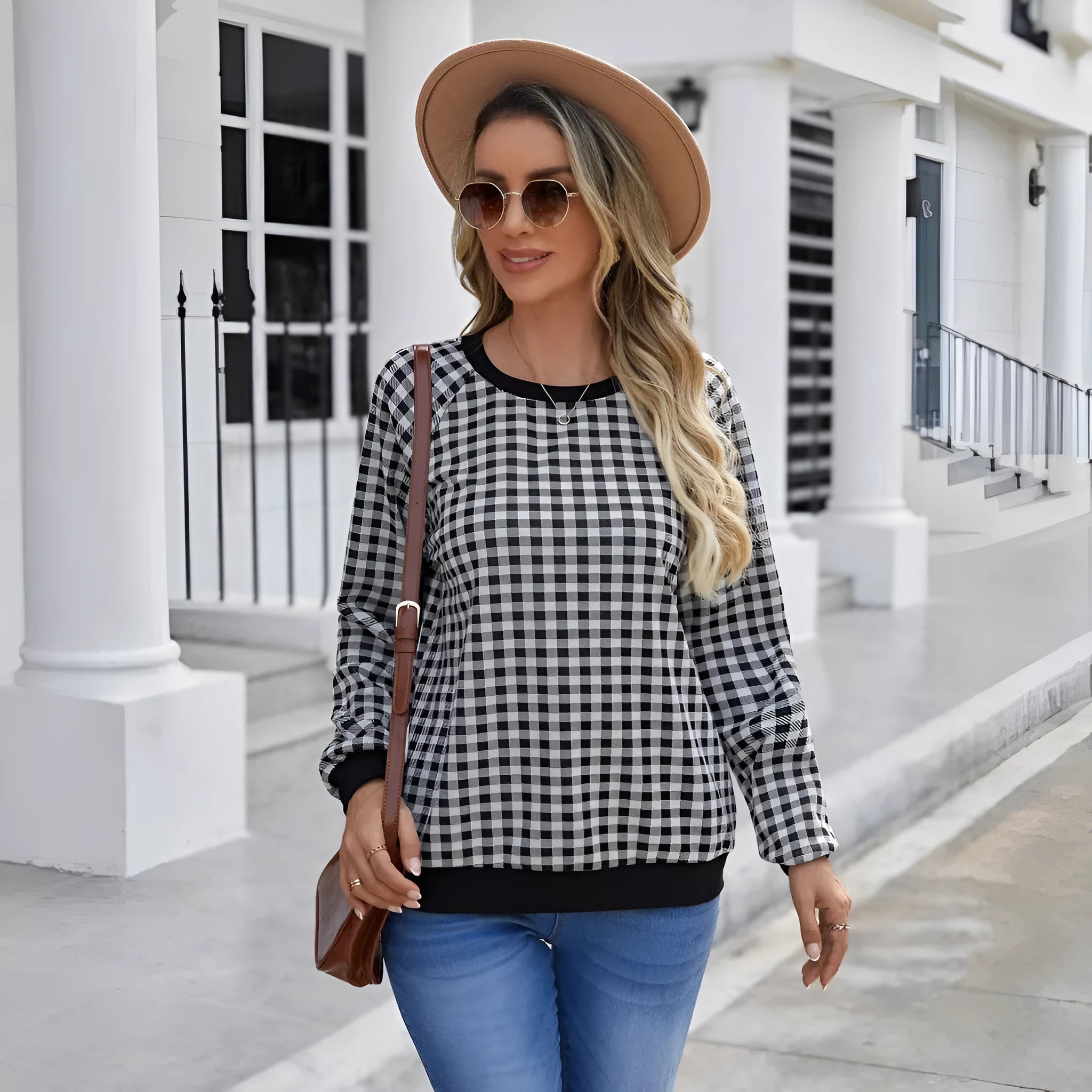 Black long sleeve pullover sweater with a striped plaid pattern and printed design detail.
