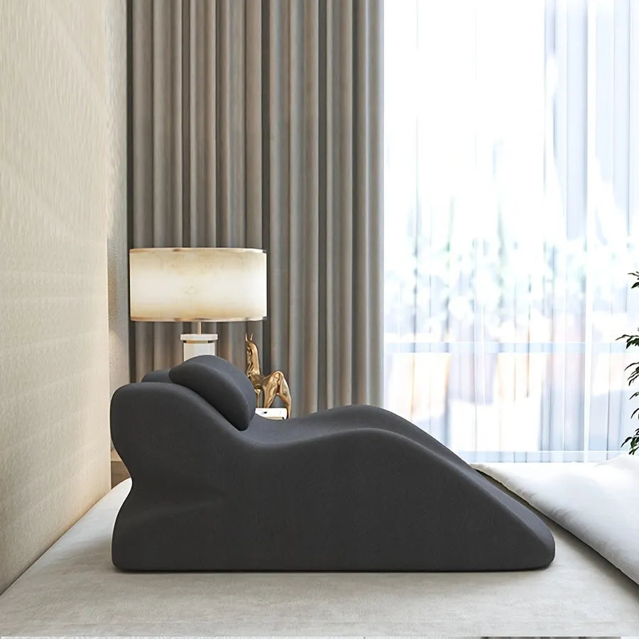 Ergonomic stomach sleeper pillow for reading in bed, shown in blue colour