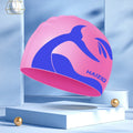 Silicone swim cap with waterproof ear protectors featuring whale tail design in multiple colours