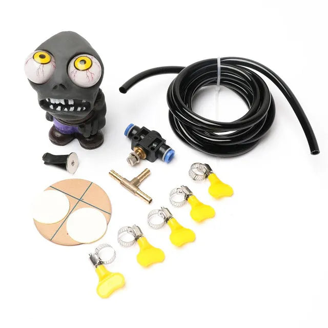 Car turbo boost sound kit with explosive eye doll, pressure valve, copper tube, and fittings on a dark background.