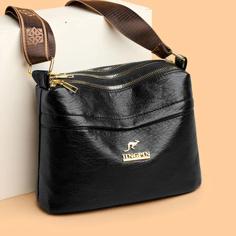 Large capacity multi compartment cross body bag in black with horizontal square shape and sewing thread detail