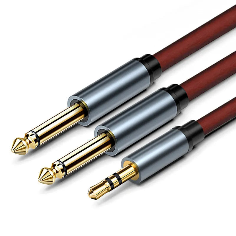 3.5mm to 6.35mm male-to-male audio cable with gold-plated connectors on a black coiled cable.