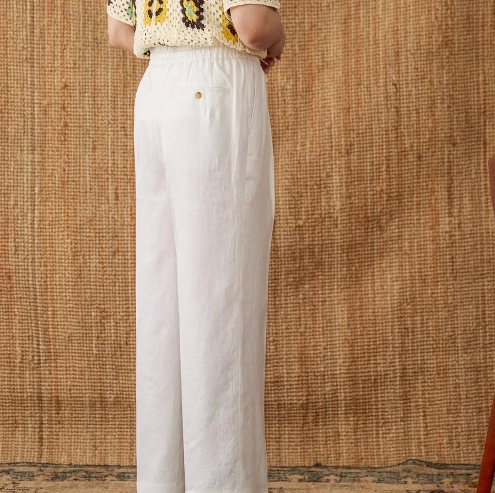 Women's linen straight-leg trousers with elasticated high waist and lace trim in navy blue colour.