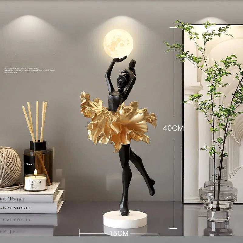 Small resin night light ornament in black gold colour with USB charging cable