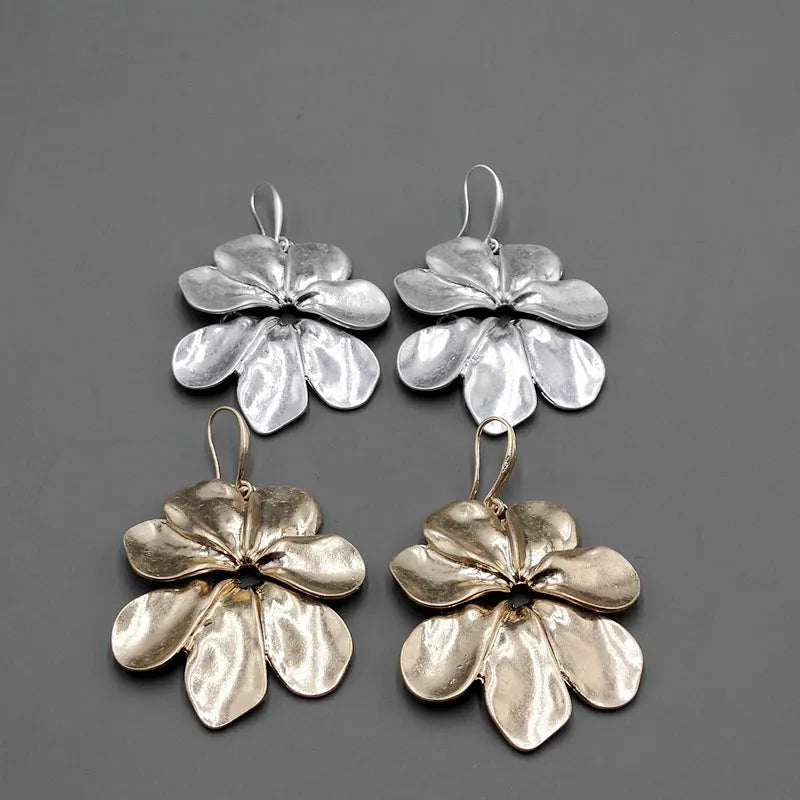 Vintage-style distressed leaf earrings for women in alloy, original silver colour finish on a plain background