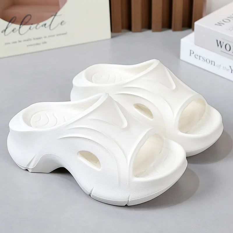 Women's white EVA slippers with thick sole and round toe on a beach background